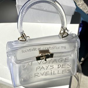 Clear Un Voyage hand bag
